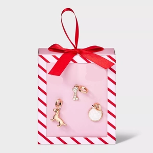 Three-piece gold jewelry set with dachshund and bone charms in a pink gift box