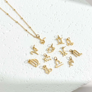 Minimalist gold titanium steel zodiac necklace set with layered beads on stone background