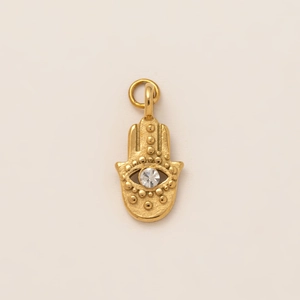 Detailed close-up of a 18K gold-plated Hamsa hand pendant with central zircon gemstone