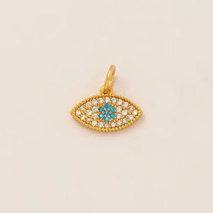 Close-up of golden Evil Eye pendant with micro-paved white stones and blue gemstone center