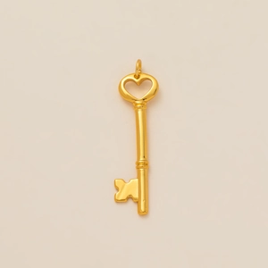 Detail shot of a golden heart-shaped key pendant in polished stainless steel for DIY jewelry
