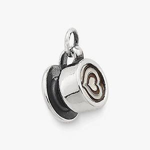 Macro detail of 18K gold-plated coffee cup pendant with heart latte art pattern