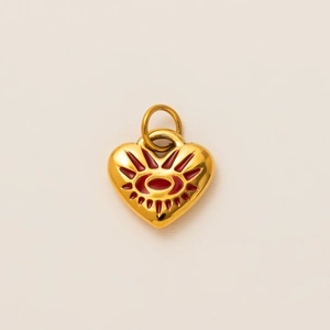 Detailed close-up of a gold heart pendant with red enamel evil eye and vacuum plating