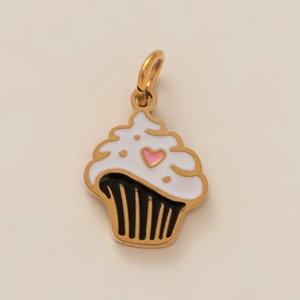 Macro shot of cupcake pendant with white enamel frosting and pink heart detail