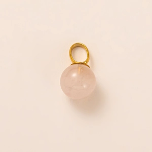 Detailed view of spherical rose quartz pendant with a polished gold bail attachment