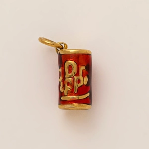 Macro shot of 18K gold plated stainless steel Dr Pepper soda can pendant with red enamel