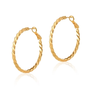 Detailed view of large golden hoop earrings with faceted twisted texture and secure leverback