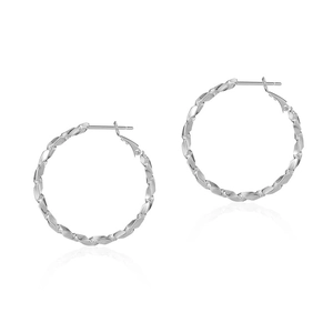 Macro detail of large silver hoop earrings featuring a unique twisted geometric design