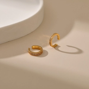 Detail shot of C-shaped 18K gold-plated ear cuffs with double rows of pavé cubic zirconia