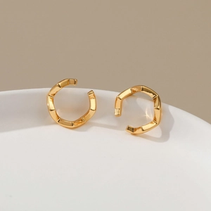 Detail of 18K gold plated brass ear cuffs with micro-pave cubic zirconia on ceramic tray