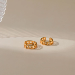 Detailed view of 18K gold plated brass ear cuff featuring hollow star designs