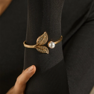 Modern gold leaf bangle for women with sparkling rhinestones and a white pearl accent
