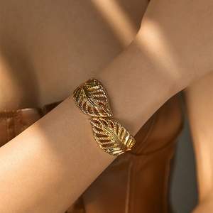 Macro detail of golden irregular leaf cuff bracelet with intricate vein textures