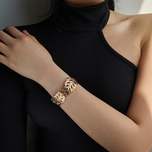 Modern gold hollow leaf bracelet with sparkling crystals on a female model wrist