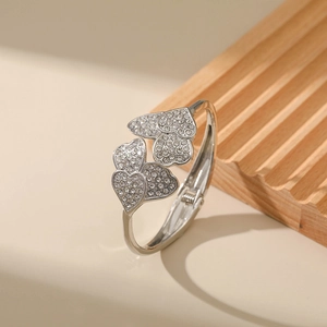 Macro shot of silver heart-shaped bracelet with pave-set rhinestones and spring clasp