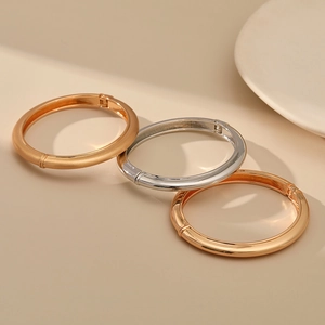 Detailed view of stackable matte and polished minimalist hinged bangle bracelets