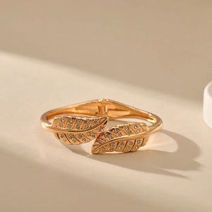 Macro view of gold leaf bracelet with cubic zirconia details and hinge clasp mechanism