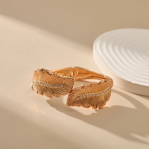 Close-up of golden leaf bracelet featuring detailed veins and sparkling zircon stones
