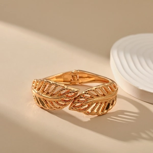 Detailed view of golden leaf cuff bracelet featuring intricate hollowed vein textures
