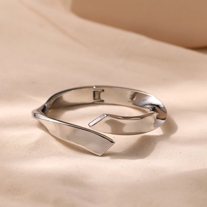 Minimalist silver zinc alloy open cuff bracelet with a modern twisted irregular design