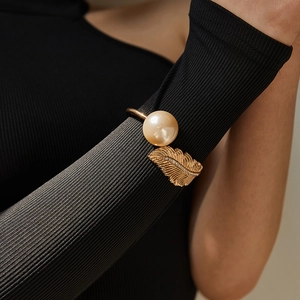 Modern gold feather cuff bracelet with large faux pearl and sparkling crystal accents