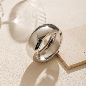 Macro shot of silver polished wide dome cuff bangle with reflective mirror finish