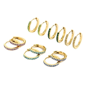 Set of six gold huggie earrings with colorful sparkling rhinestones on white background