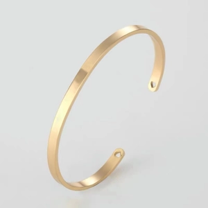 Polished 18k gold plated stainless steel open cuff bracelet with heart cut-out ends