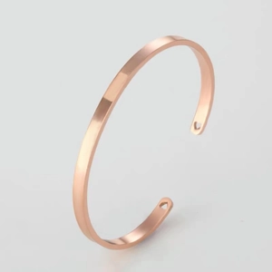 Polished 18k rose gold plated stainless steel open bangle with heart cutout details