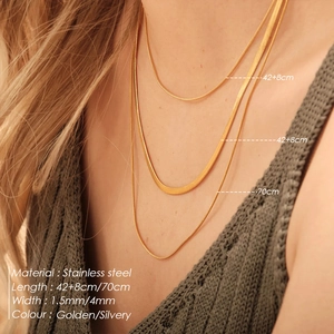 Detail of layered golden stainless steel necklaces showing 1.5mm and 4mm snake chains