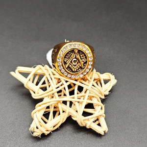 Detail shot of a golden Masonic G ring featuring micro-pave crystals and black enamel work