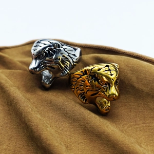 Detailed view of gold and silver tiger head rings with intricate engraved animal fur textures