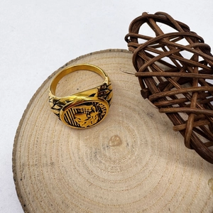 Detailed view of the gold Caesar signet ring featuring embossed portrait and vintage patterns
