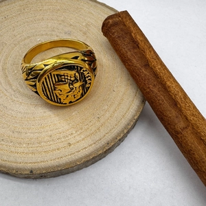 Detail view of Caesar engraving on vintage gold-tone stainless steel signet ring for men