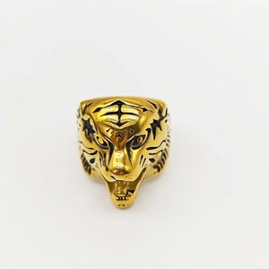 Detailed top view of golden tiger head ring with intricate black engraved facial features