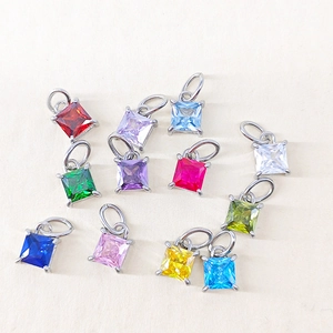 Macro view of colorful square-cut gemstone pendants with silver claws for DIY jewelry