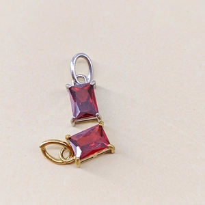 Detailed view of rectangular ruby birthstone charms in gold and silver plating