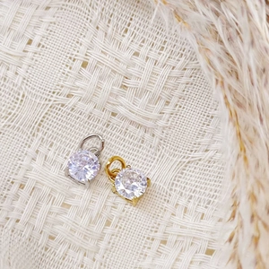 Detail of silver and gold stainless steel round zircon pendants for jewelry making