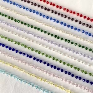 Colorful faceted crystal bead necklaces in 11 vibrant shades on a clean white background