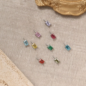 Detail of colorful rectangular zirconia birthstone pendants on a vintage tray display