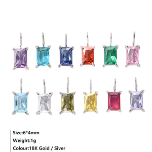 Macro shot of 12 multi-colored rectangular zircon charms in gold and silver finish