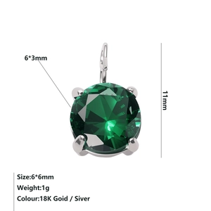 Macro detail of a 6x6mm green zircon stone pendant with silver 4-claw setting