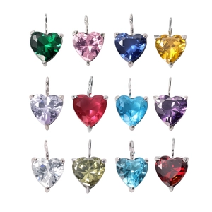 Macro display of 12 multi-colored heart-shaped zircon pendants with silver claw settings