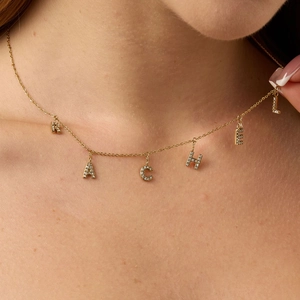 Custom gold initial necklace with Rachel spelling featuring sparkling micro-pave zirconia