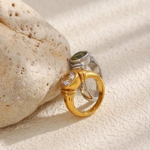 Close-up of vintage wide rings in gold and silver finish with oval zircon stones