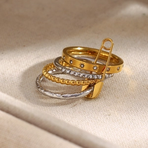 Macro shot of a four-layer stacked ring set with pin detail and 18K gold finish