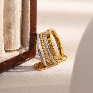 Close-up of four-layer stackable 18K gold plated rings with star engraving and pin detail