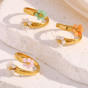 Detail of adjustable 18K gold plated steel rings with colorful beaded flower designs