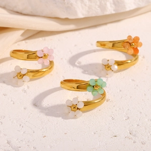 Detailed macro of 18K gold plated spiral rings with colorful miniature floral accents