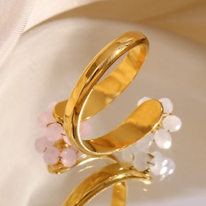 Detail of adjustable 18K gold plated ring with delicate pink and white floral beads